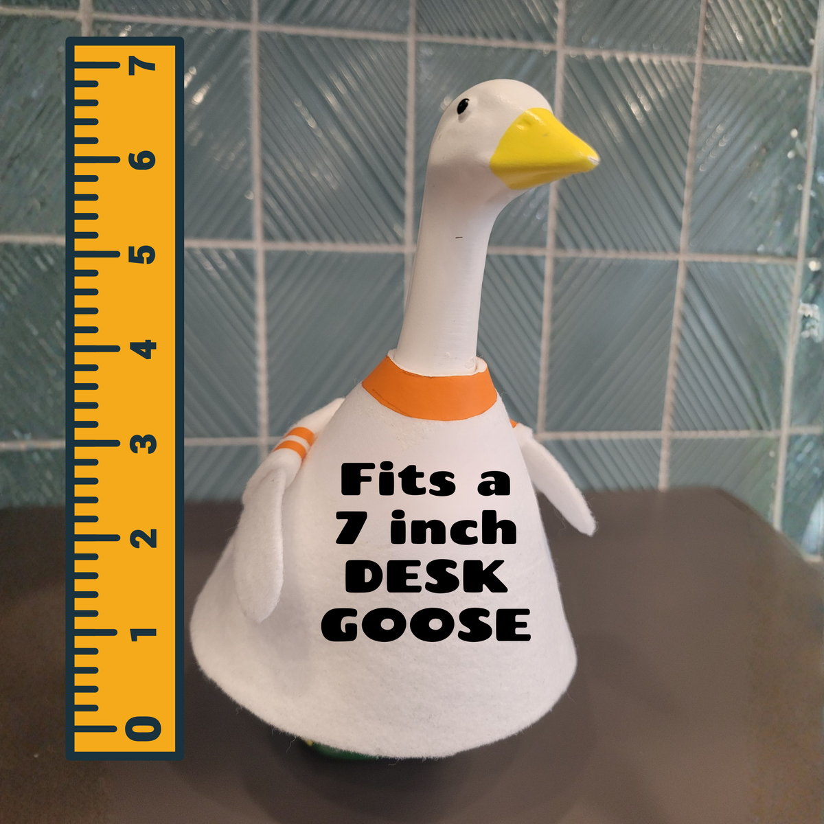 A miniature goose statue dressed in a handmade outfit